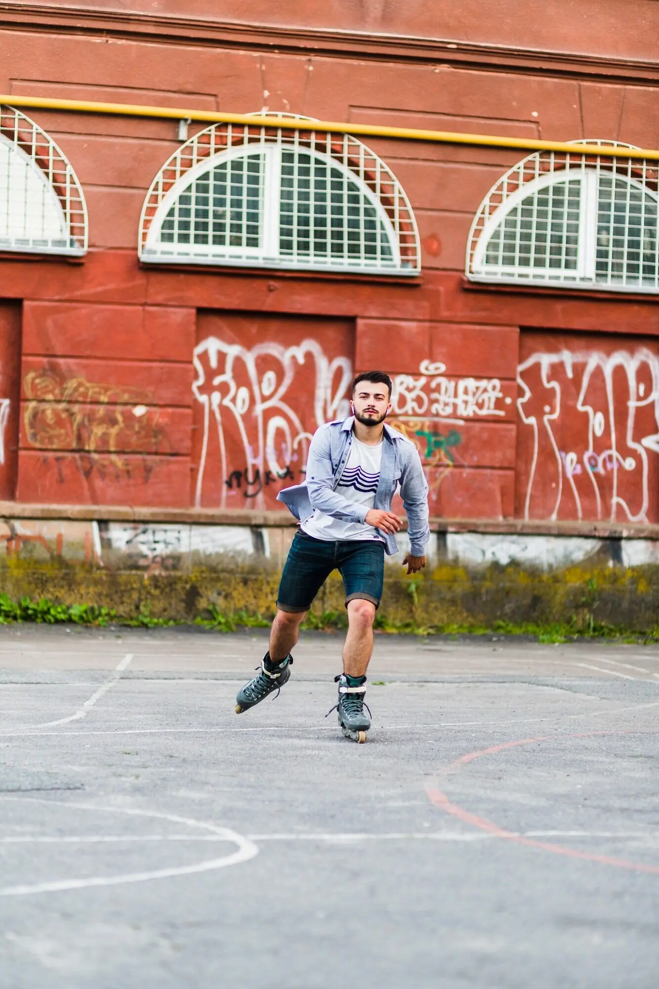 Hombre joven patinando sobre ruedas en una cancha al aire libre